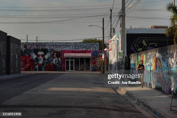 Lone person is seen running along a street in the Wynwood neighborhood on March 31, 2020 in Miami, Florida. Most businesses and have shut and...