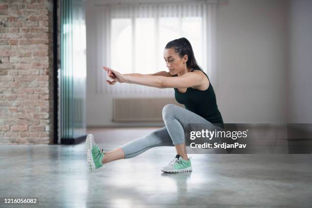 doing some pistols - agachar se imagens e fotografias de stock