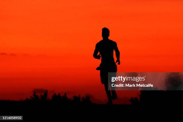 Jogger runs along the Bondi to Bronte coastal walk as the sun rises on April 01, 2020 in Sydney, Australia. The Australian government has introduced...