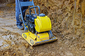 Vibratory plate compactor in construction rammer ground compaction foundation for construction of underground