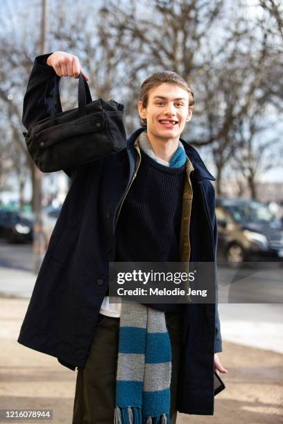 Model Audi Bizar holds a bag and wears a black coat after the Sacai show on January 18, 2020 in Paris, France.