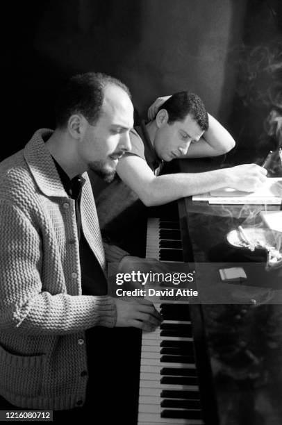 Songwriters and producers Jerry Leiber and Mike Stoller compose a song during a photo shoot for Vogue Magazine in Stoller's apartment in 1959 in New...