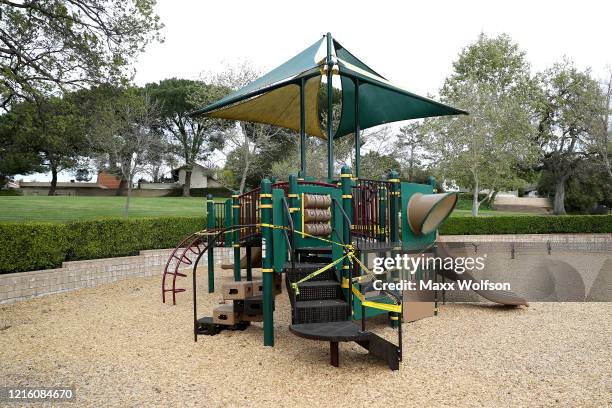 Caution tape is placed over the equipment at Berniece Bennett Park to prevent people from gathering on March 31, 2020 in Westlake Village,...