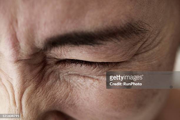midleage woman,skin close-up - squinting stock pictures, royalty-free photos & images