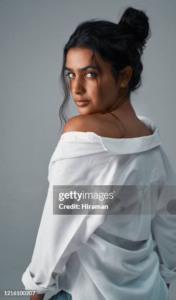 i like it a little off the shoulder - woman looking over shoulder serious stock pictures, royalty-free photos & images