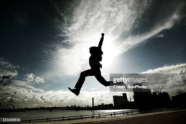 businessman jumping - river asia cityscape business day imagens e fotografias de stock