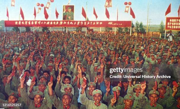 People's Liberation Army soldiers march carrying the 'Little Red Book' by Chairman Mao. 1967.