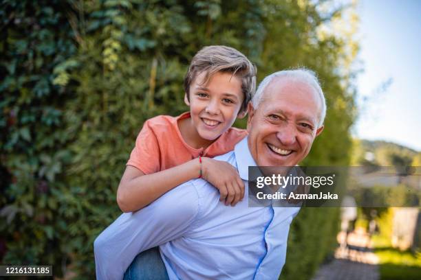 playful grandfather and piggyback grandson - povo espanhol e povo português imagens e fotografias de stock