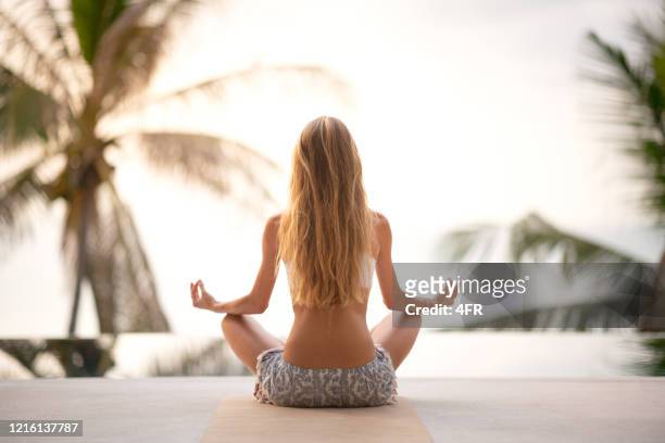 woman connecting with nature, yoga meditation outdoor at sunrise, zen state - blonde yoga stock pictures, royalty-free photos & images