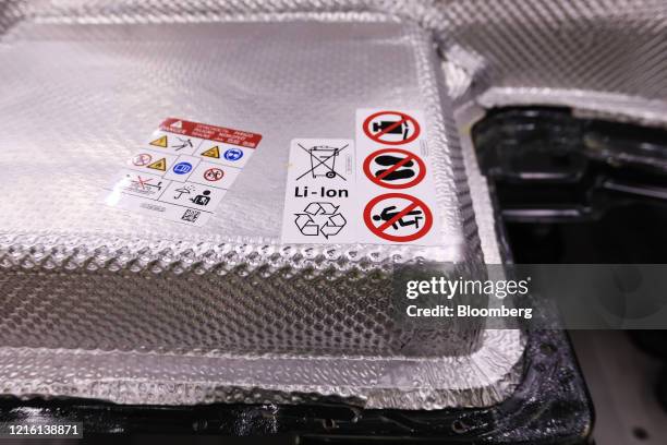 Recycling symbol sits on a lithium-ion battery pack of a Volkswagen e-Golf electric automobile at the Volkswagen AG factory in Dresden, Germany, on...
