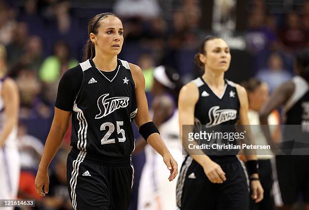 Becky Hammon and Tully Bevilaqua of the San Antonio Silver Stars walk back to their bench during the WNBA game against the Phoenix Mercury at US...