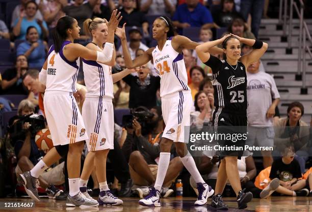 DeWanna Bonner of the Phoenix Mercury high-fives Candice Dupree and Penny Taylor after scoring past Becky Hammon of the San Antonio Silver Stars...