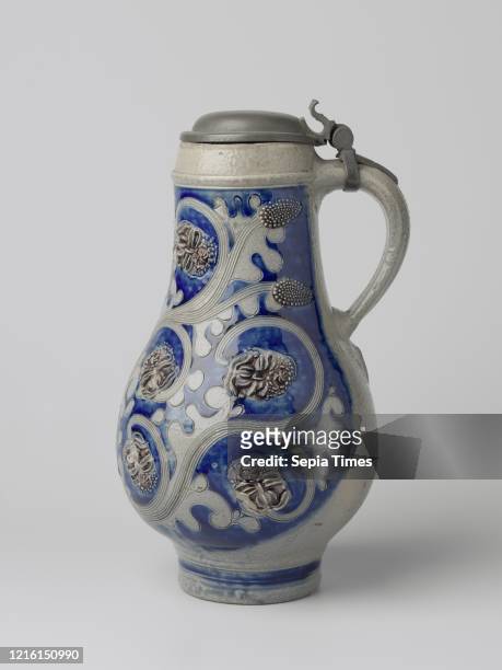 Jug with a stylized flowering plant, Stoneware jug on a high foot with a pear-shaped body and wide neck. The C-shaped ear is attached to the neck and...