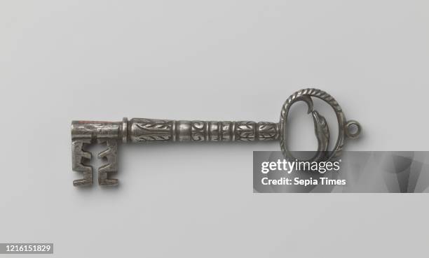 Key, Key with oval handle in which there is a snake and which is crowned by an eye. The handle is grooved on the outside with sloping lines. The...