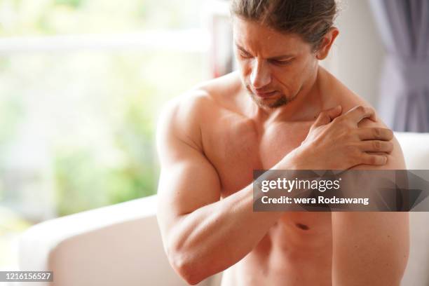 sportsman have pain muscle injuries from the exercise related - man touching shoulder imagens e fotografias de stock