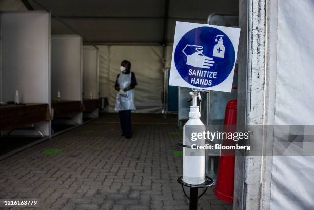 Bottle of hand sanitizer stands at the entrance to a mandatory staff health check area at the BMW South Africa Pty Ltd. Rosslyn plant in Midrand,...