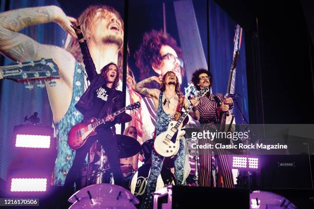 Dan Hawkins, Rufus Taylor, Justin Hawkins and Frankie Poullain of British rock group The Darkness performing live on stage at Chantry Park in Ipswich...