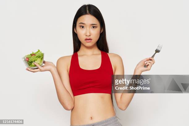 confused woman shrug hands holding vegetarian food in hands salads fresh vegetables. - lady cooking confused imagens e fotografias de stock