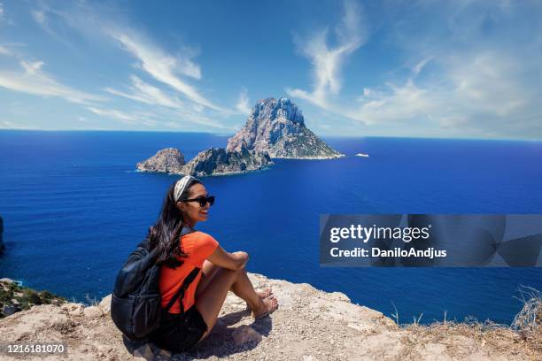 young beautiful woman sitting on the edge - ibiza strand stock pictures, royalty-free photos & images