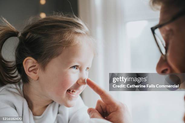 blob of lotion - girl gets cream on the nose stock pictures, royalty-free photos & images