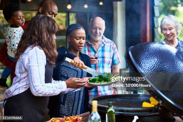 friends serving healthy food from barbecue - group of friends out to lunch stock pictures, royalty-free photos & images