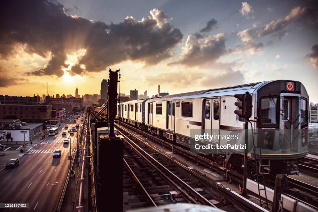 Elevated Subway Train and New York City Skyline