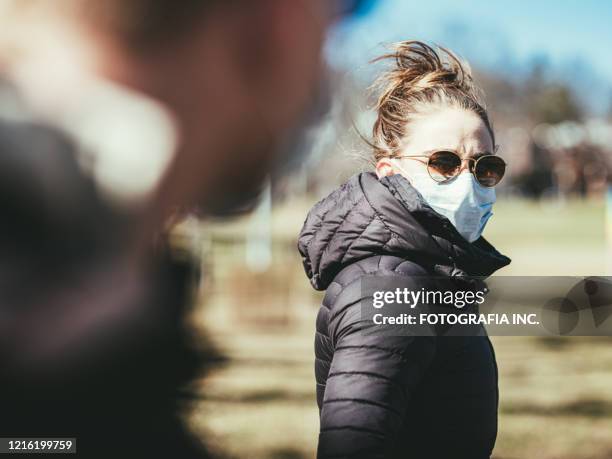 covid-19, young couple meeting outside - coronavirus dating stock pictures, royalty-free photos & images