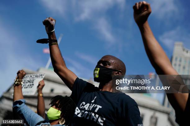 Protestors wears masks with the message "I Still Can't Breathe" during a vigil at Foley Square in New York on May 29, 2020 against the death of...