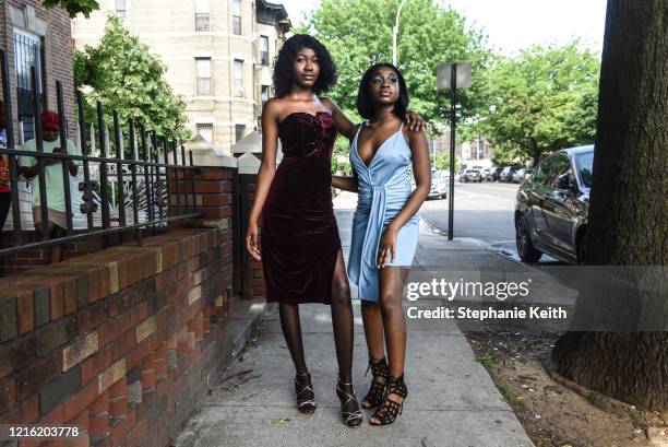 Marry Ousmane poses with Patrice Toussaint outside while wearing their prom dresses on May 29, 2020 in the Brooklyn borough in New York City. Marry...