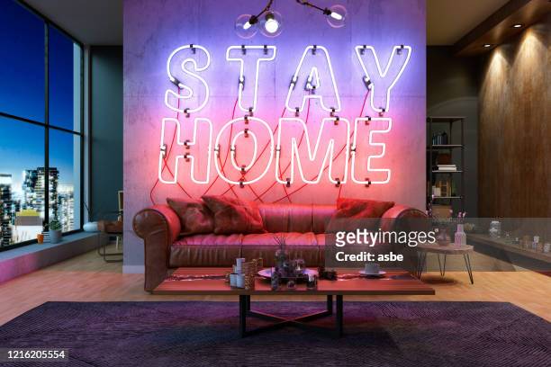 neon stay at home sign con cpzy interior quarantine concept - quedarse en casa frase fotografías e imágenes de stock