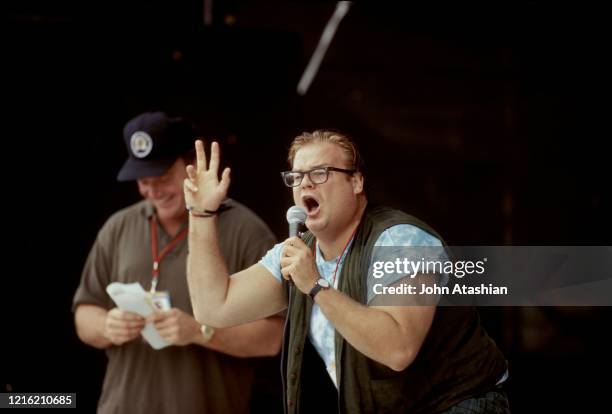 Comedians Tom Arnold and Chris Farley are shown talking to the crowd in between performance at Woodstock '94 on August 13, 1994.