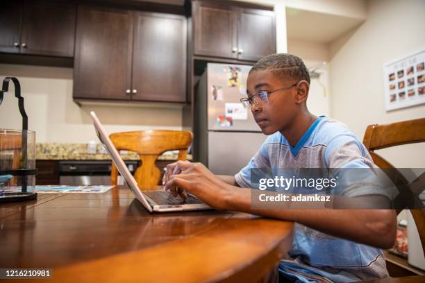 young black boy homeschooling - distance learning kid stock pictures, royalty-free photos & images