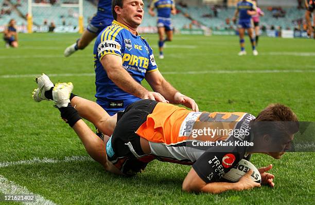 Blake Ayshford of the Tigers dives over to score a try during the round 24 NRL match between the Wests Tigers and the Parramatta Eels at Sydney...