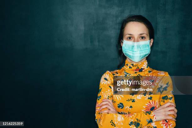 woman wearing protective face mask during covid-19 pandemic - classroom masks stock pictures, royalty-free photos & images