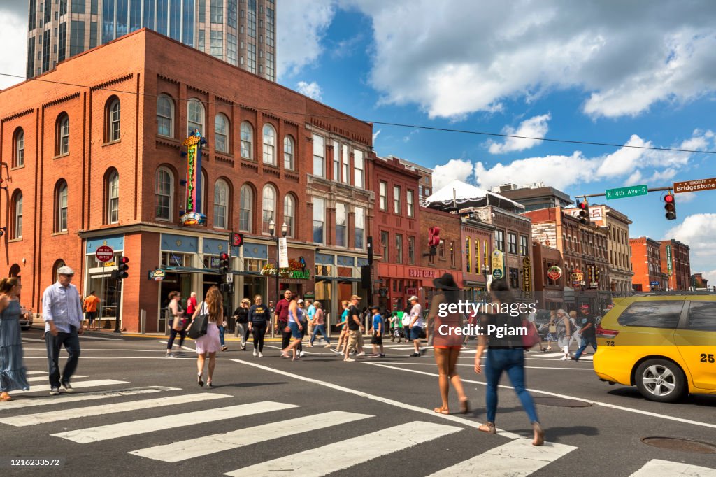People walk along Broadway in Nashville Tennessee USA