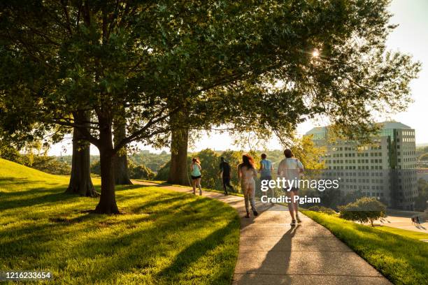 people exercise and run in a public park in nashville tennessee usa - nashville park stock pictures, royalty-free photos & images