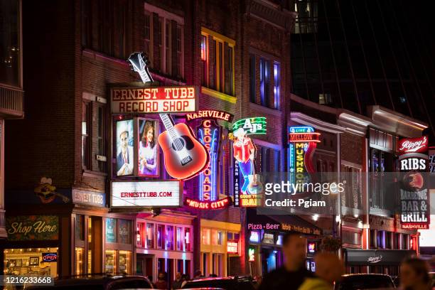 people walk along broadway in nashville tennessee usa - broadway street stock pictures, royalty-free photos & images