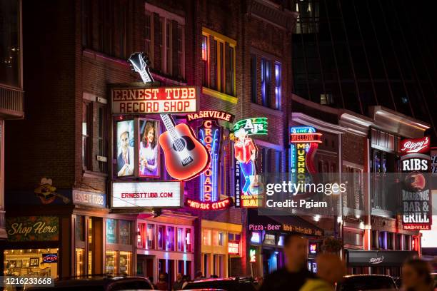 people walk along broadway in nashville tennessee usa - nashville imagens e fotografias de stock