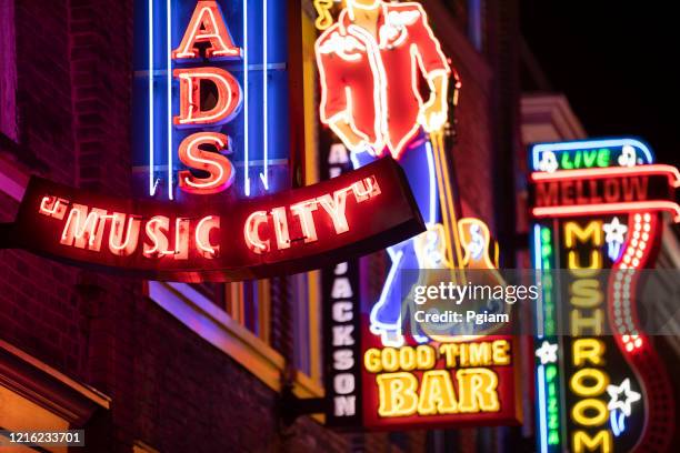 neon signs along the broadway in downtown nashville tennessee usa - tennessee music stock pictures, royalty-free photos & images