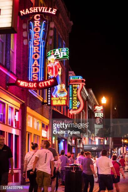 neon signs along the broadway in downtown nashville tennessee usa - nashville stock pictures, royalty-free photos & images