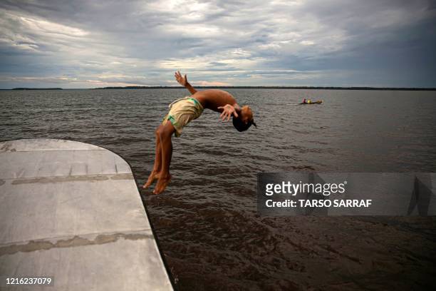 Child jumps into the water at Melgaco bay, southwest of the Marajo island, in Para state, Brazil, on May 29 amid the coronavirus pandemic.