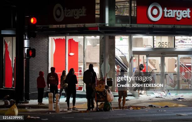 Looters rob a Target store as protesters face off against police in Oakland California on May 30 over the death of George Floyd, a black man who died...