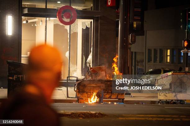 Dumpster is lit on fire infront of a Target store in Oakland California on May 30 over the death of George Floyd, a black man who died after a white...