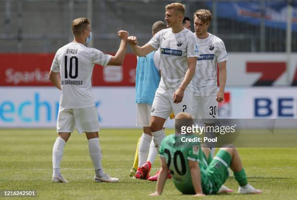 Sandhausen players Julius Biada and Aleksandr Zhirov celebrate victory during the Second Bundesliga match between SV Sandhausen and Hannover 96 at...