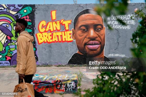 Graffiti depicting a portrait of George Floyd, a black man who died in Minneapolis after a white policeman kneeled on his neck for several minutes is...