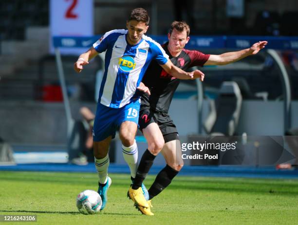 Marko Grujic of Hertha BSC and Stephan Lichtsteiner of FC Augsburg battle for the ball during the Bundesliga match between Hertha BSC and FC Augsburg...