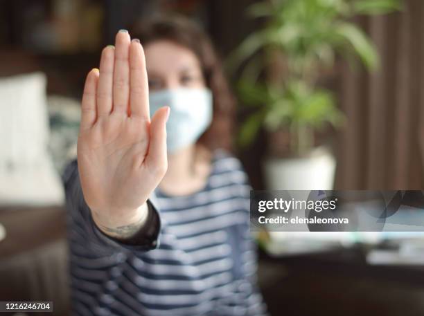 beautiful young woman working at home ( in the mask) - home violence stock pictures, royalty-free photos & images