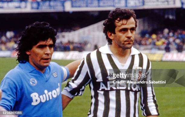 Diego Armando Maradona of SSC Napoli, embraces Michel Platini of Juventus during the Seria A Italy.