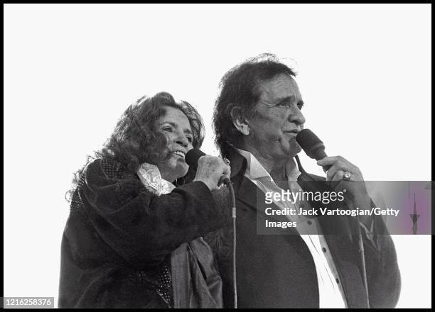Married American Country singers June Carter Cash and Johnny Cash perform onstage during a Billy Graham rally in Central Park, New York, New York,...
