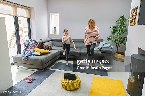 Senior lady exercising indoors with her granddaughter Senior lady exercising indoors with her granddaughter